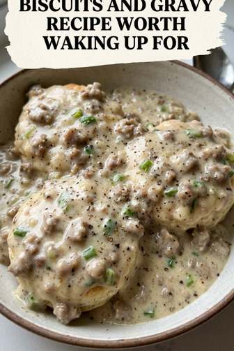 Thick homemade sausage gravy poured over split fluffy biscuits on a white ceramic plate, steam rising